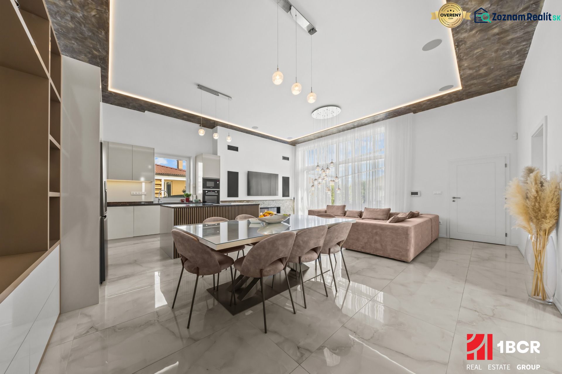 A space in a family house with a dining table and kitchen, wooden decor flooring.