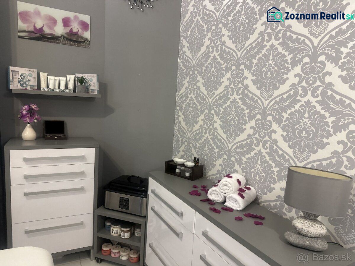 Interior of commercial spaces with white furniture, decorations, and patterned wallpaper.