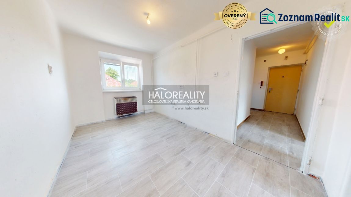 A room with light walls and a floor with a wood decor in a 2-room apartment.
