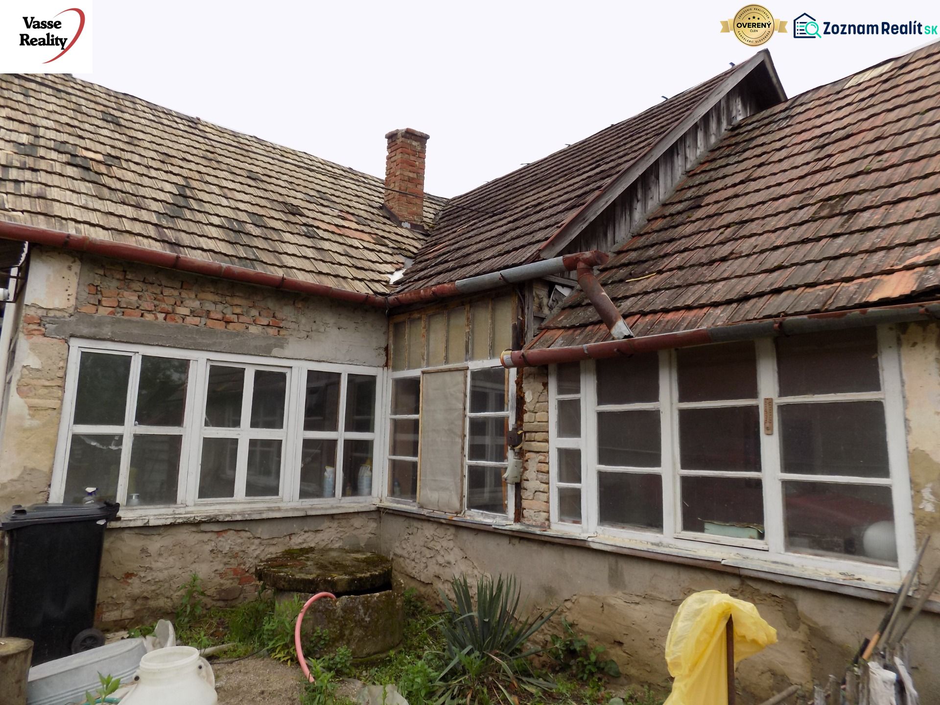 The exterior of a family house in Gbelce with a distinctive old roofing design.