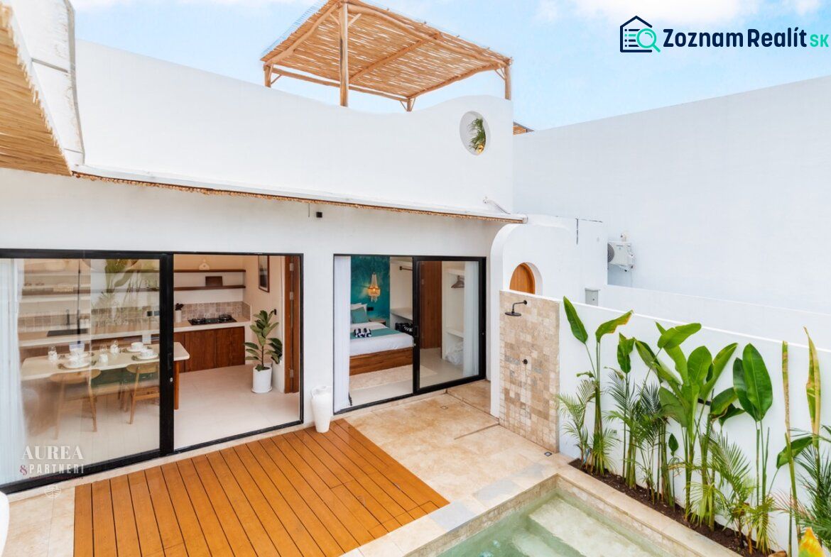 Villa in Bali with a wooden decor floor by the pool and an outdoor shower.