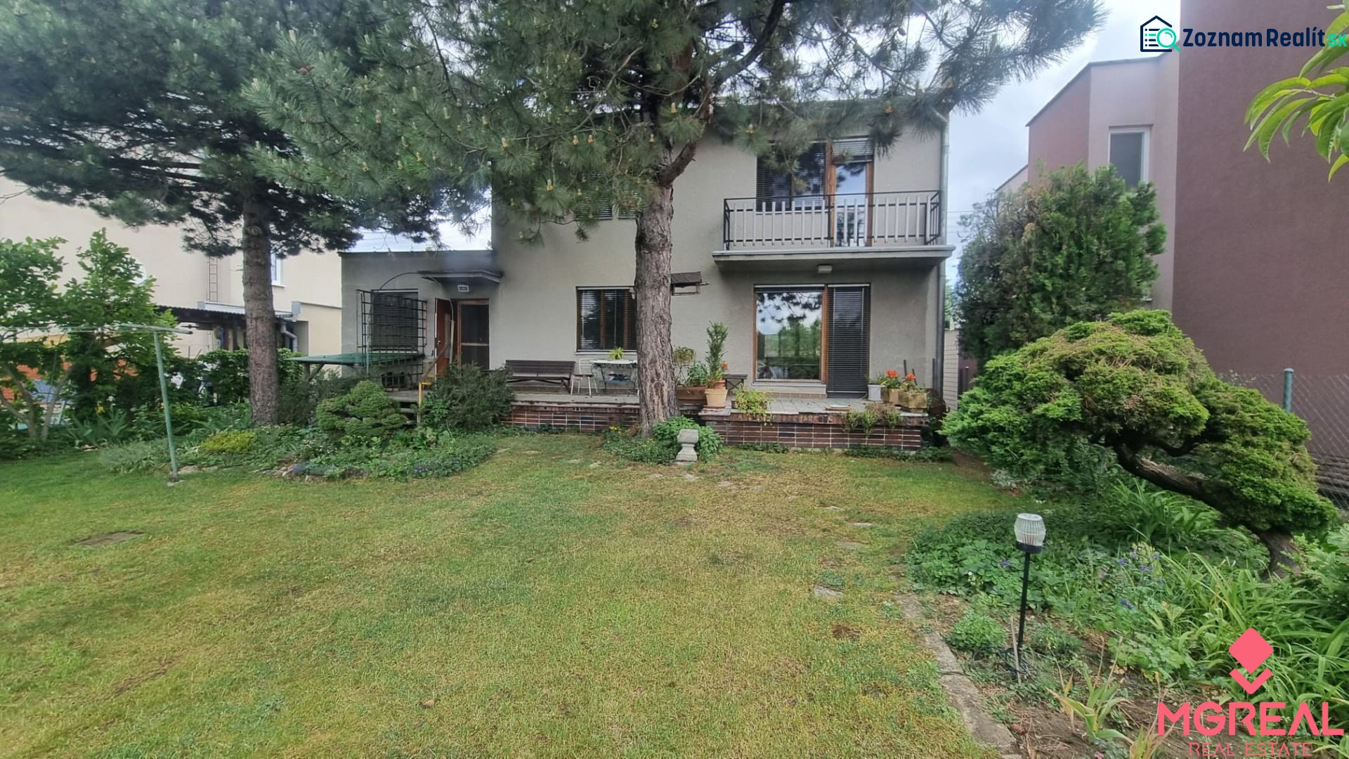 A family house in Leopoldov surrounded by a garden with a terrace and trees.