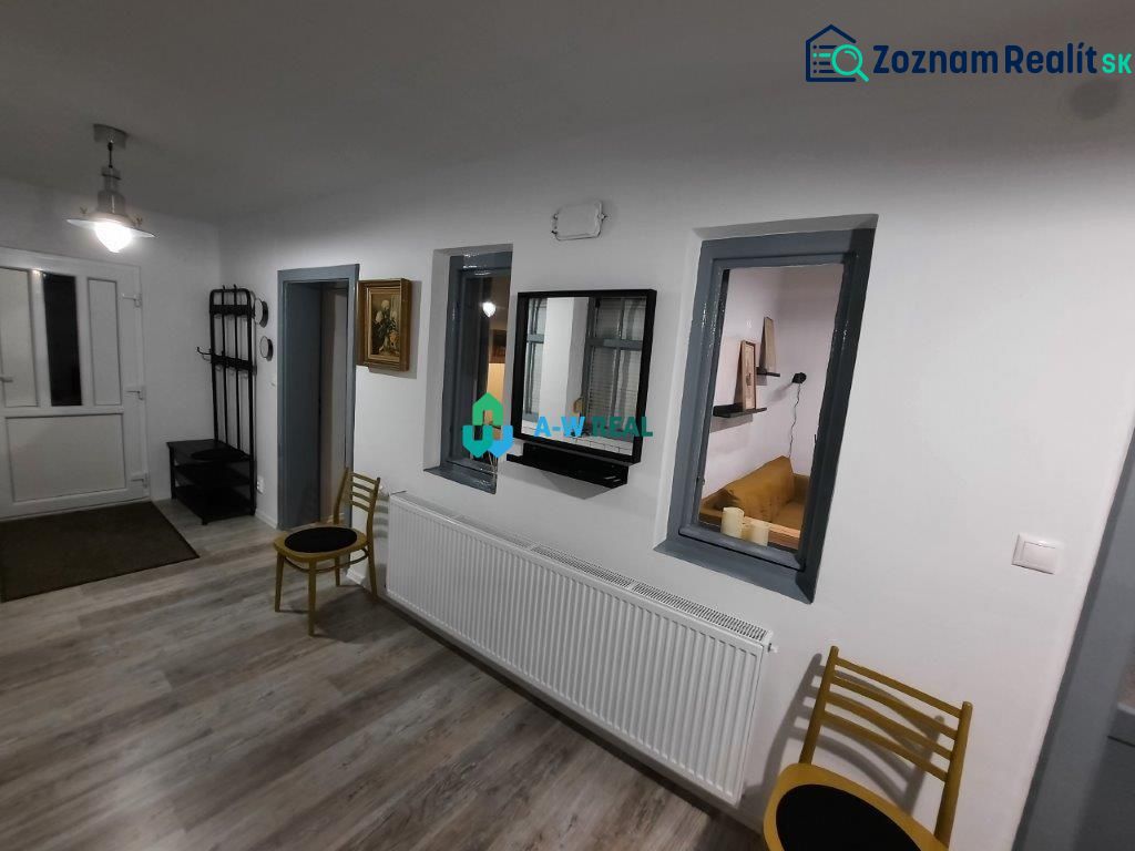 Interior of a family house with a wooden decor floor, white walls, and furniture.