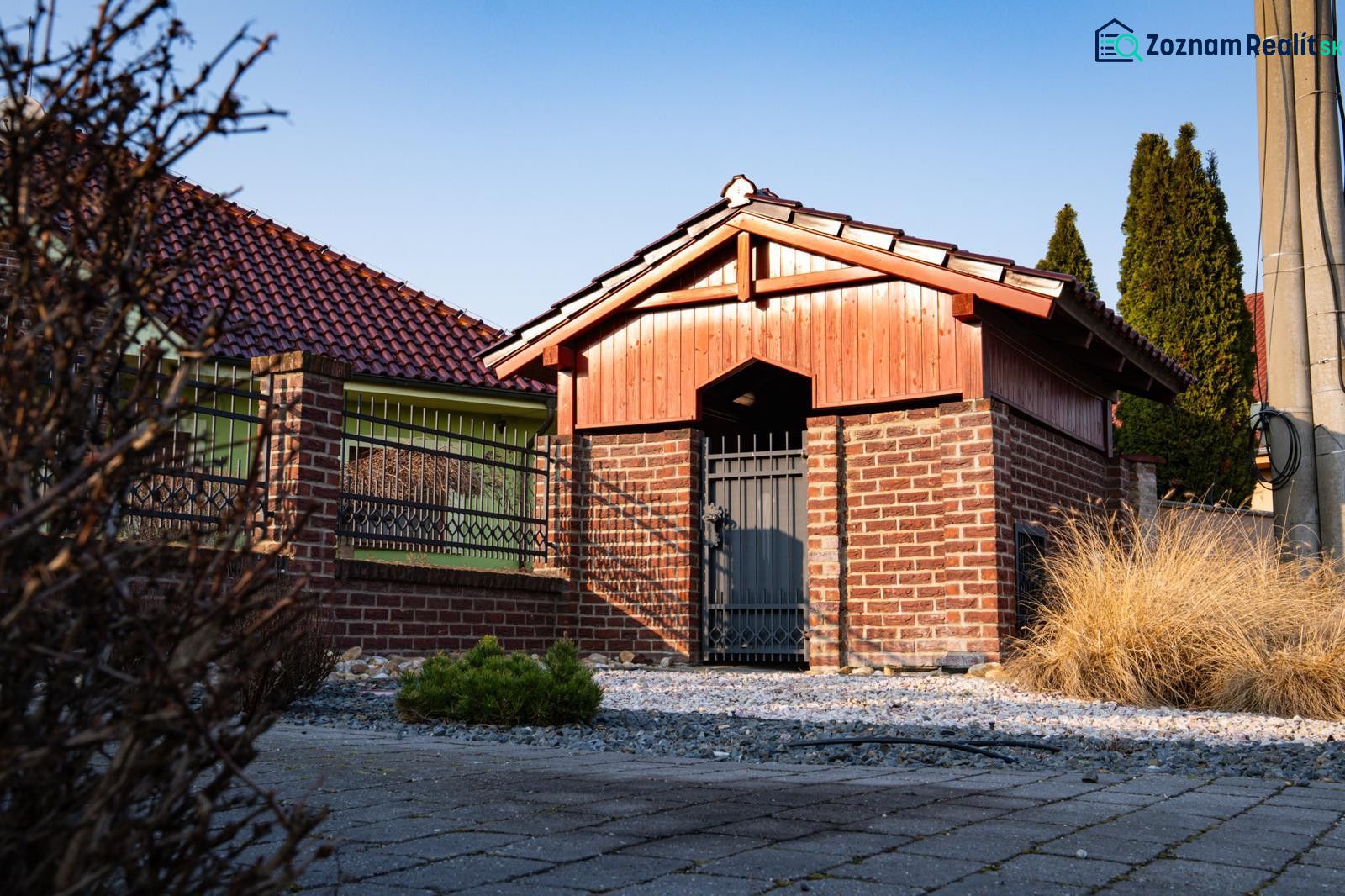 Brick and wood entrance gate to a family house in Dolný Bar.