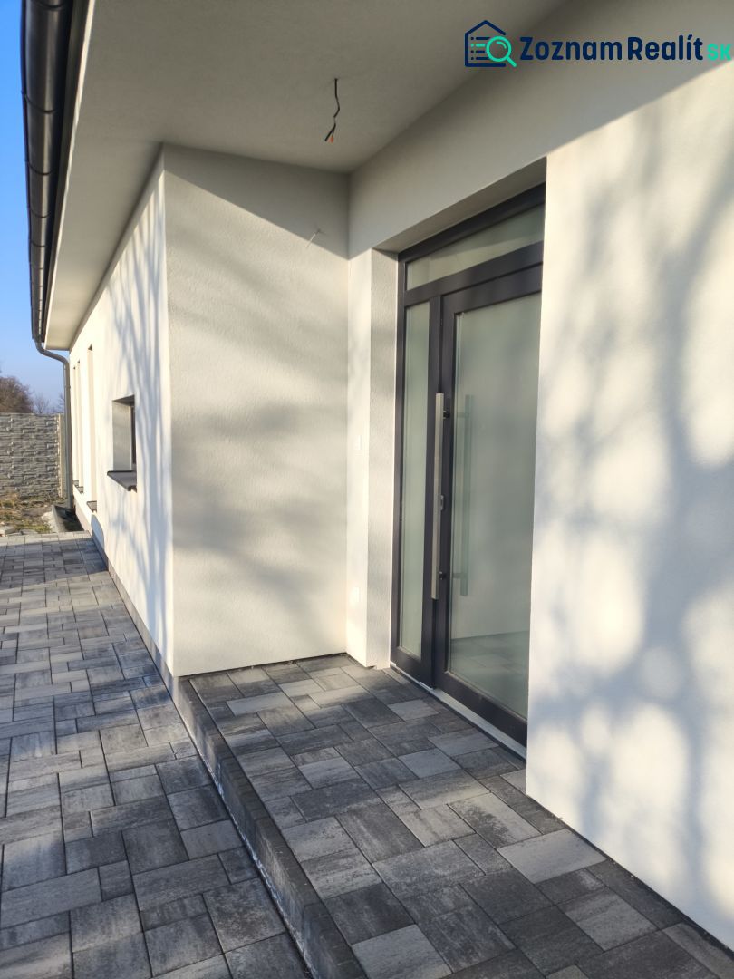 A family house in Michal na Ostrove with a terrace and glass doors.