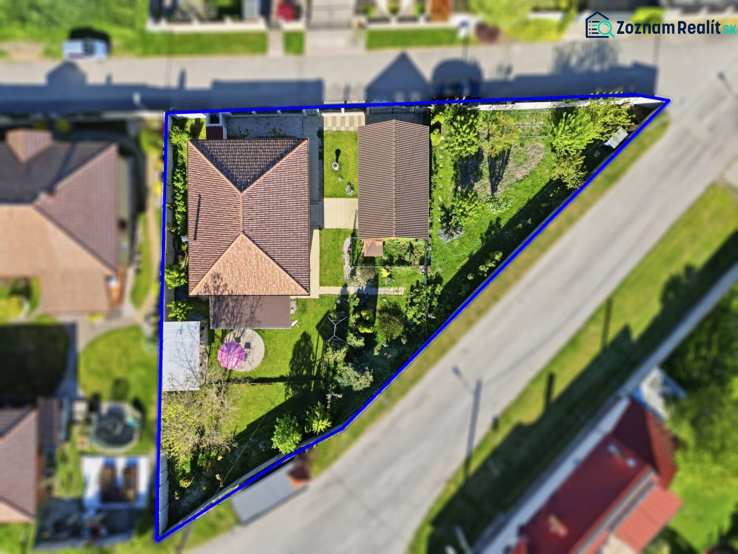 A family house with a yard and garden in Kostolné Kračany, visible from the air.