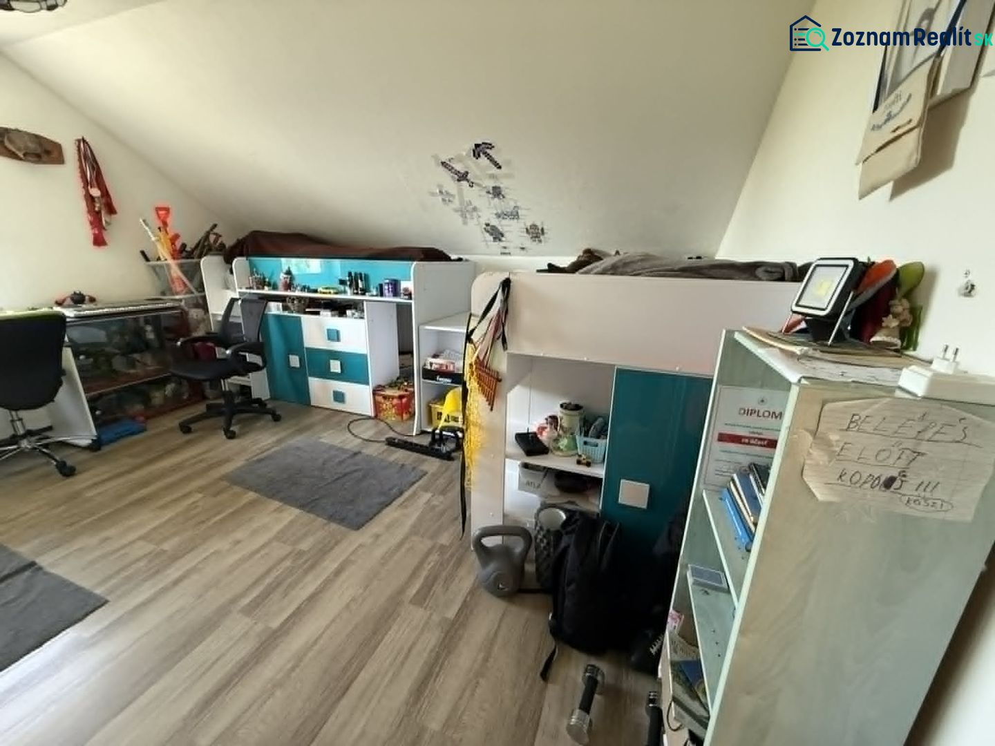 Children's room in a family house with a bunk bed and a floor with a wooden decor.