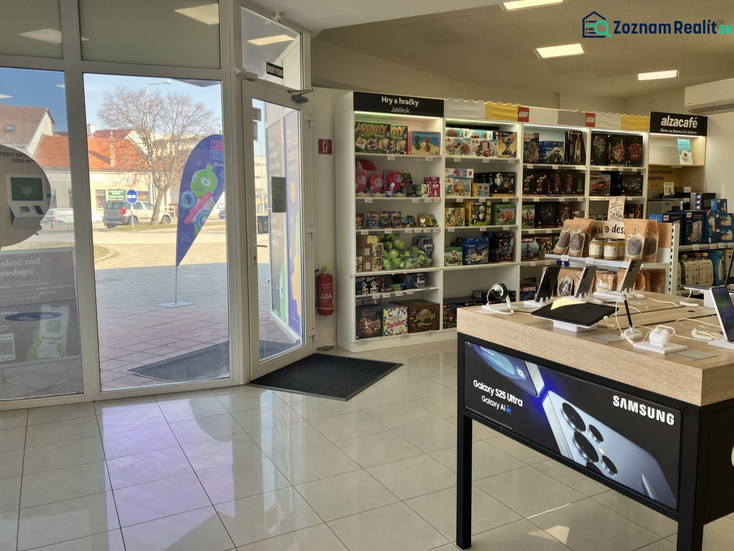 Retail spaces with electronics and toys, wooden decor flooring, light from the exterior.