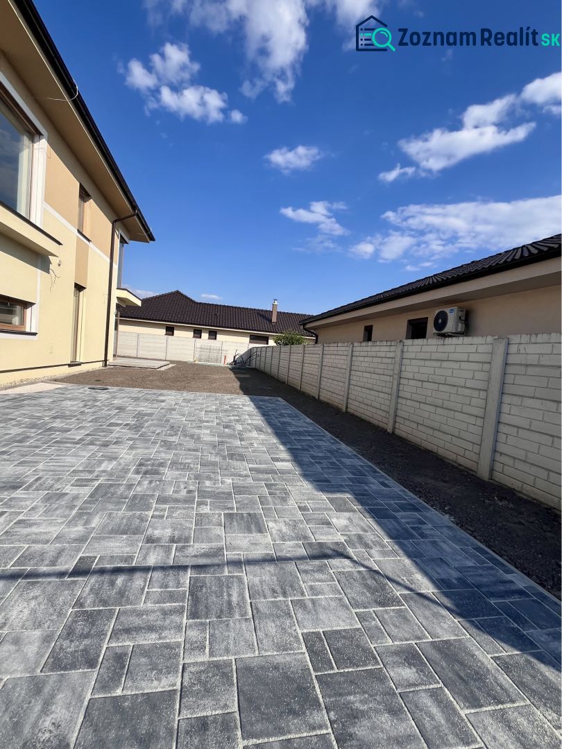 A family house in Dunajská Streda on GARDENTOWN street with a paved courtyard.