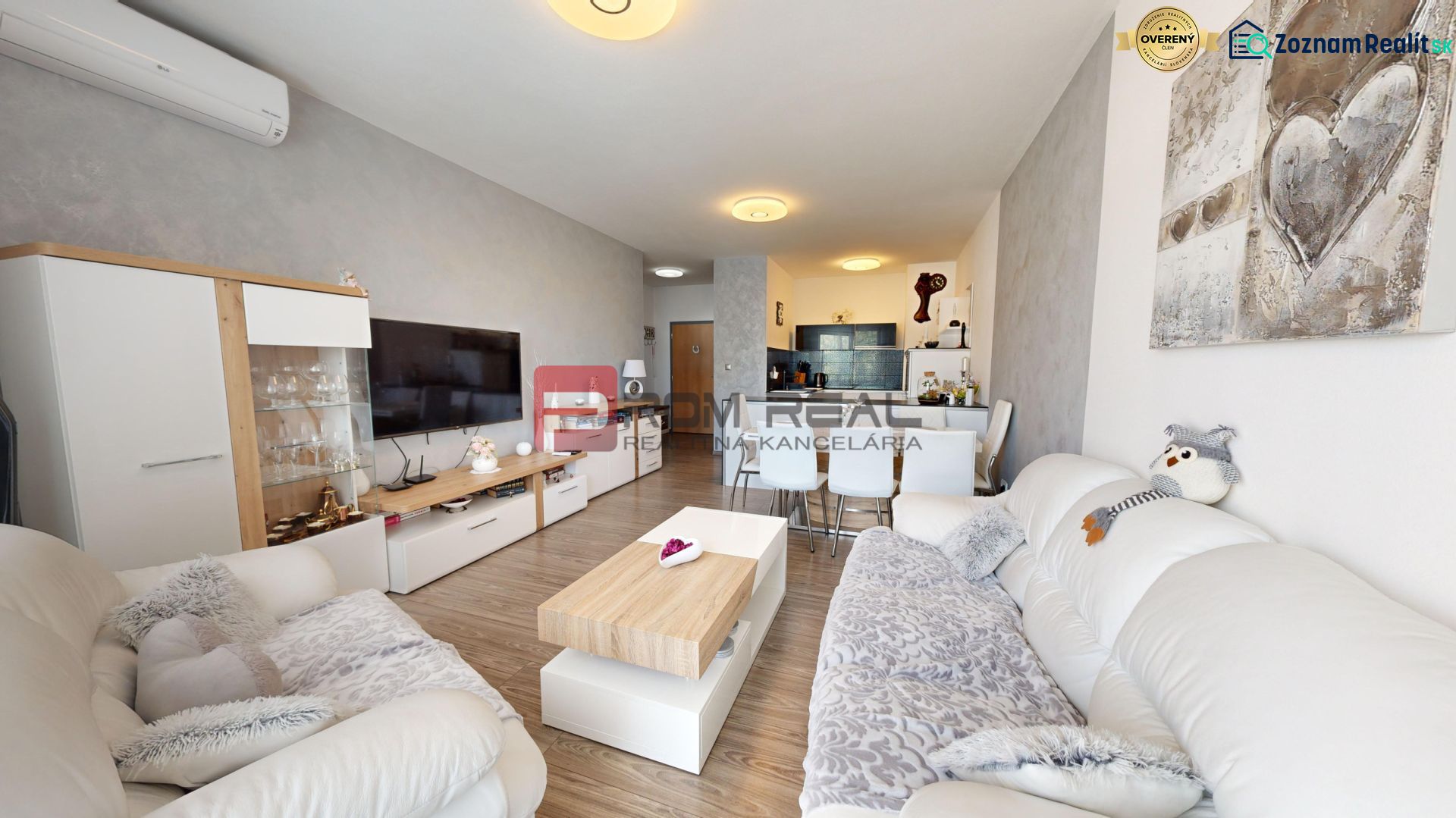 Living room with wood-patterned flooring and comfortable sofas in a two-room apartment.