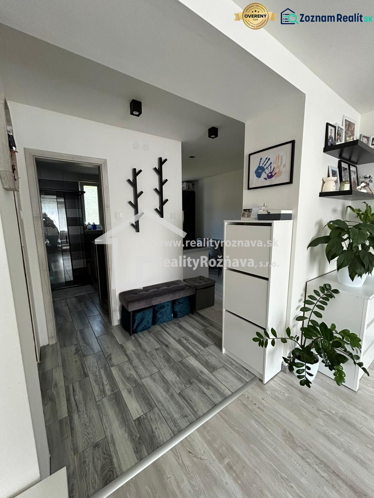 Interior of a 3-room apartment with a wooden decor floor and minimalist decorations.