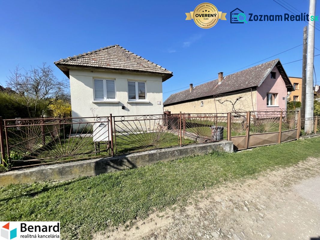 A family house on Tehelná Street in Drienov with a fenced yard and a blue sky.