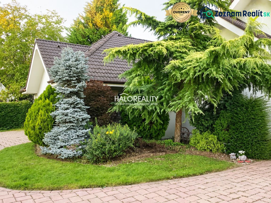 A family house in Žabokreky nad Nitrou with trees and a landscaped garden.