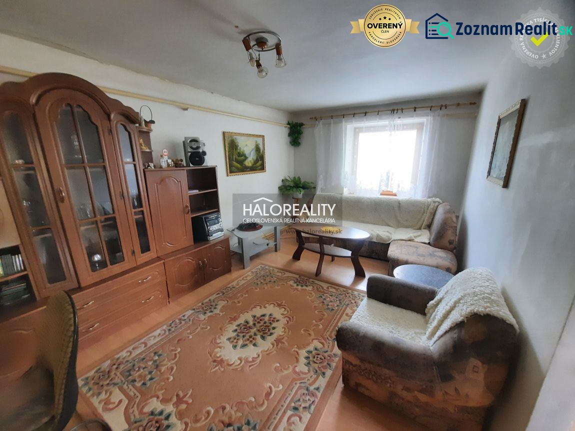Living room in a family house with sofas, carpet, and furniture.