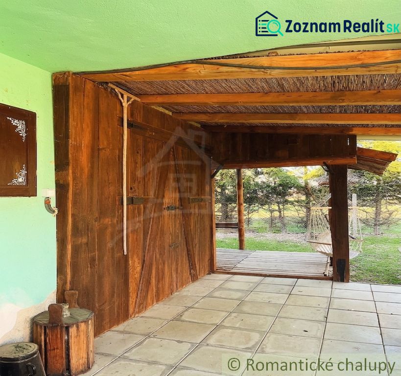 A covered terrace at a family house in Nové Hony with garden furniture and paving.