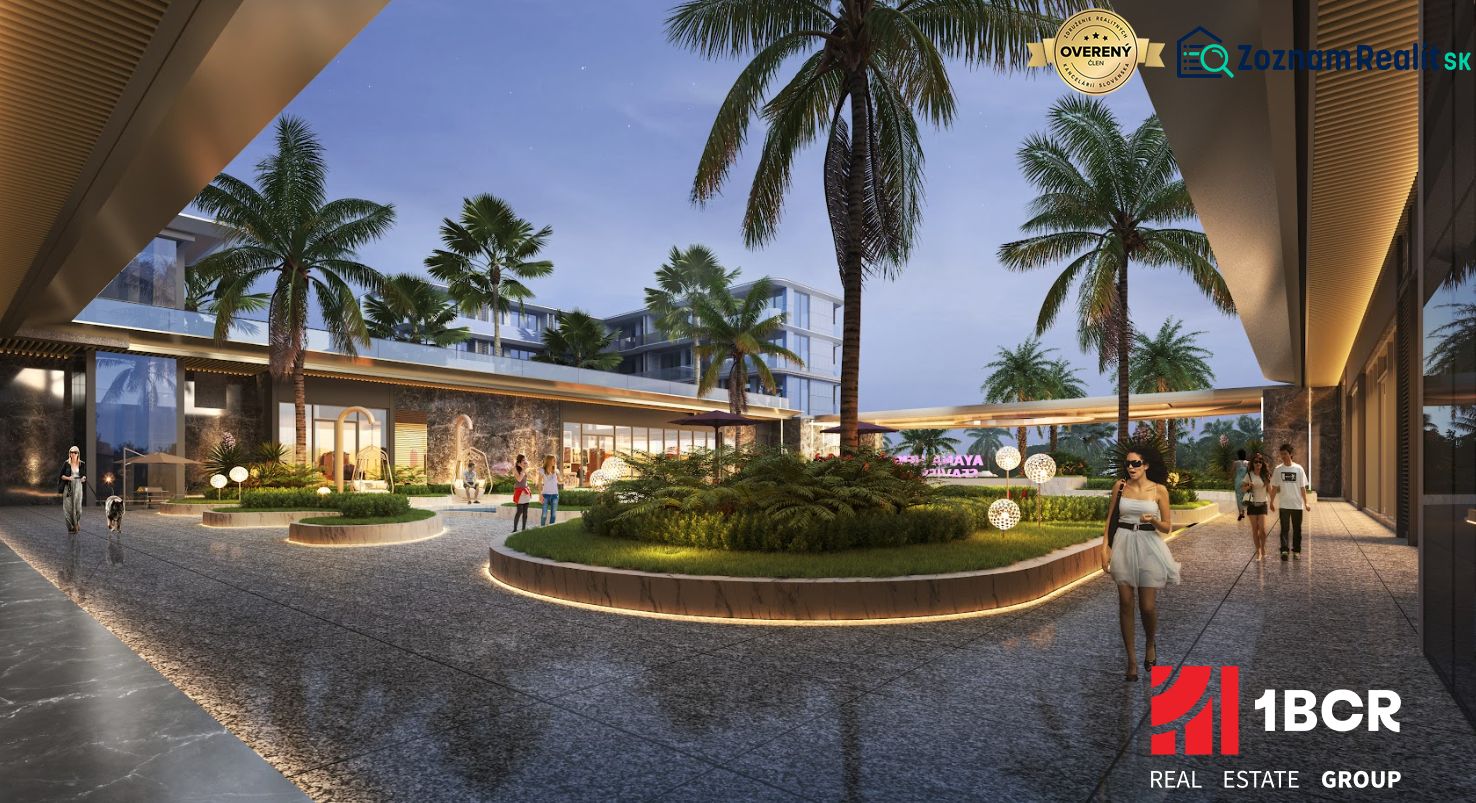 Outside the apartment construction in Phuket, palm trees and illuminated pathways can be seen.