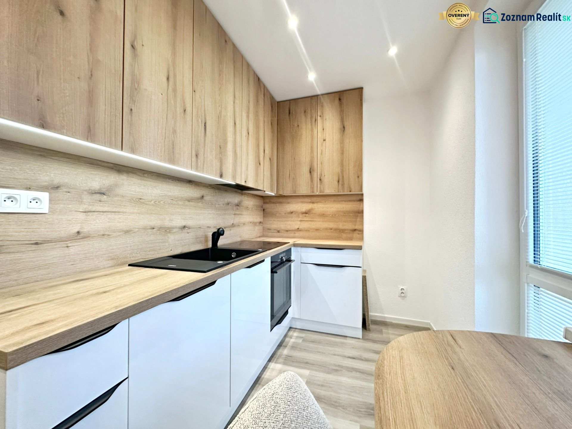 A kitchen in a 3-room apartment with wooden decor and built-in appliances.