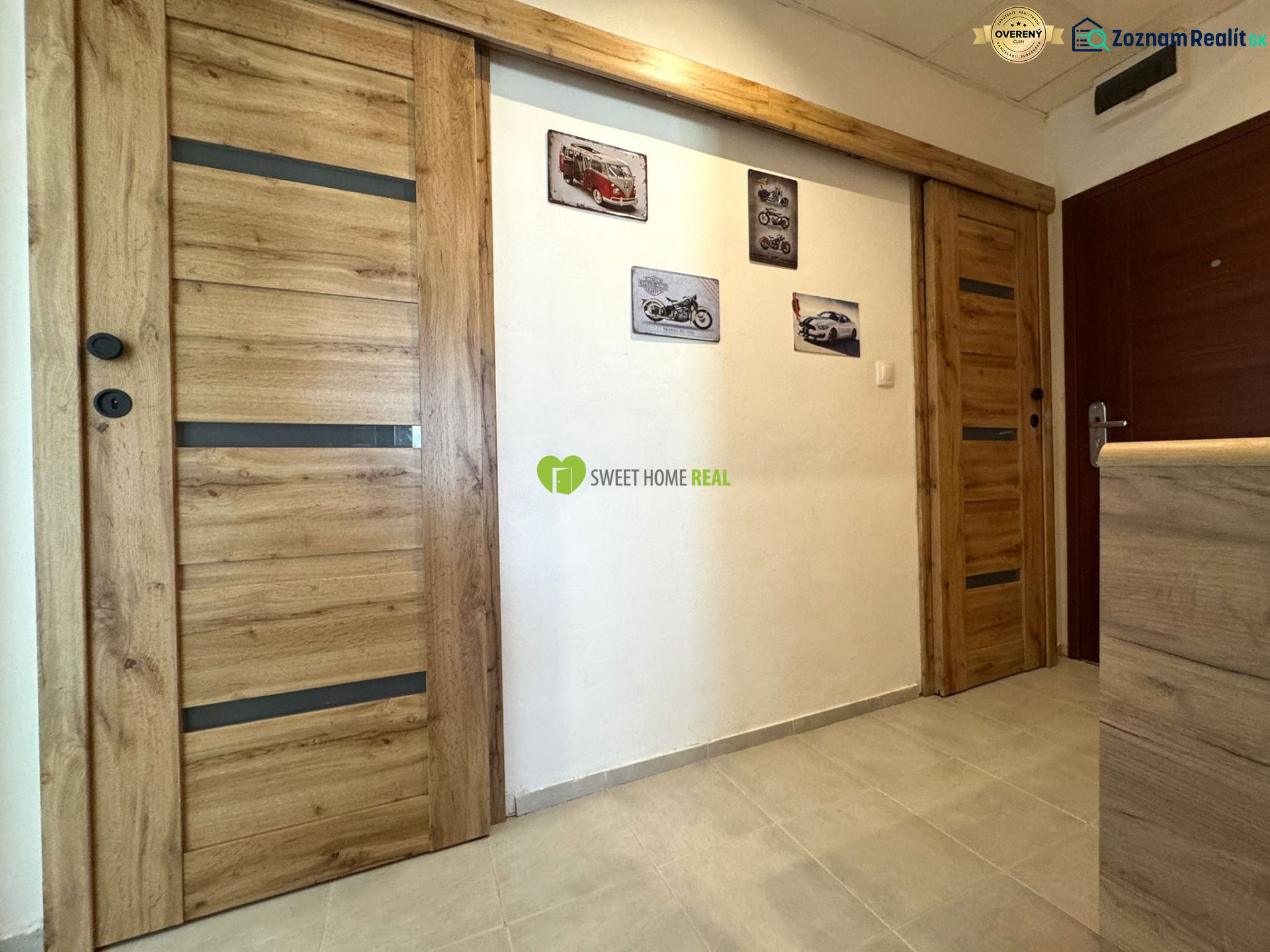 Interior of a 3-room apartment with wooden decor doors and pictures on the wall.