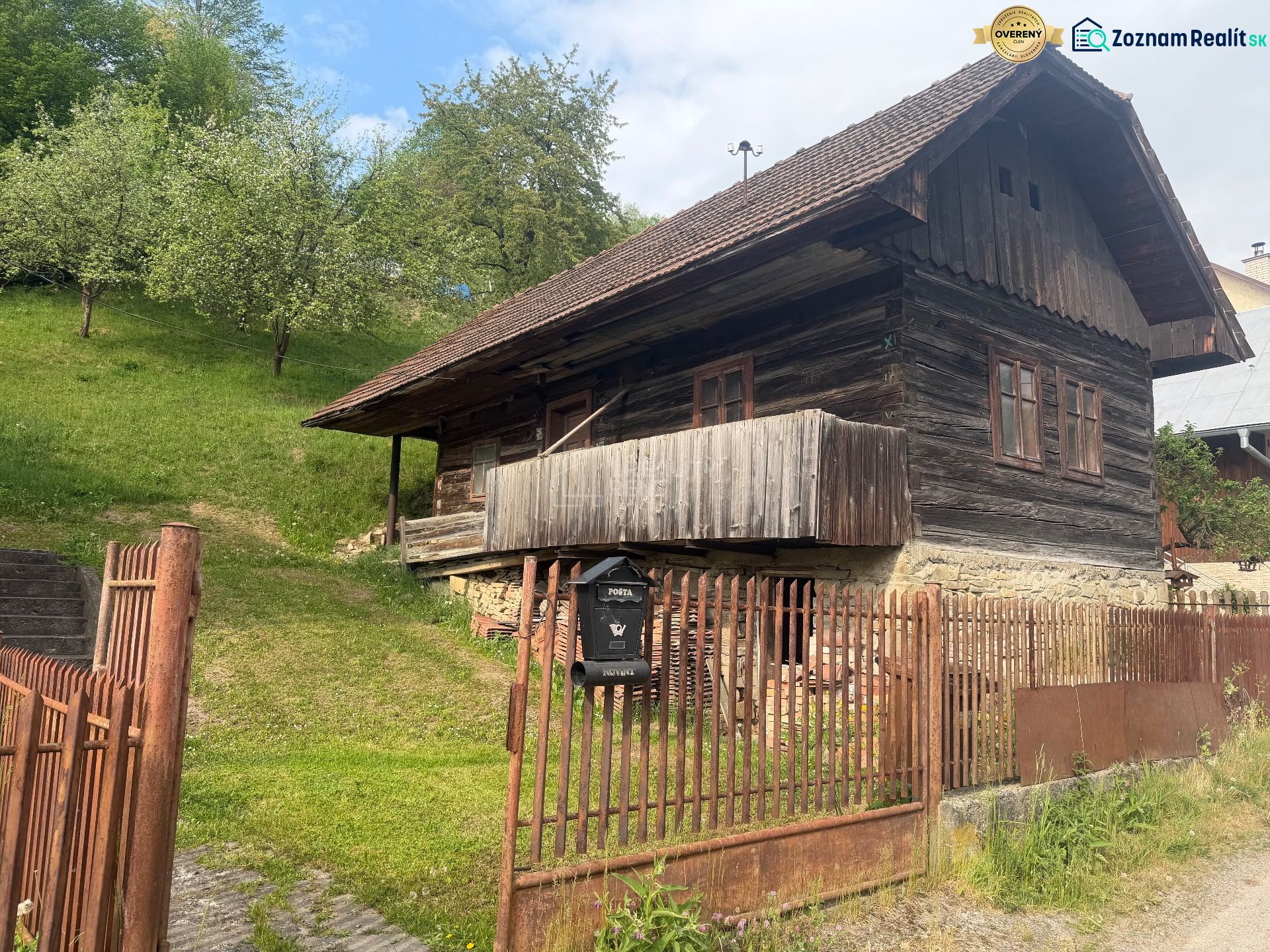 A family house in Budatínska Lehota, Kysucké Nové Mesto with a wooden cottage and green trees.