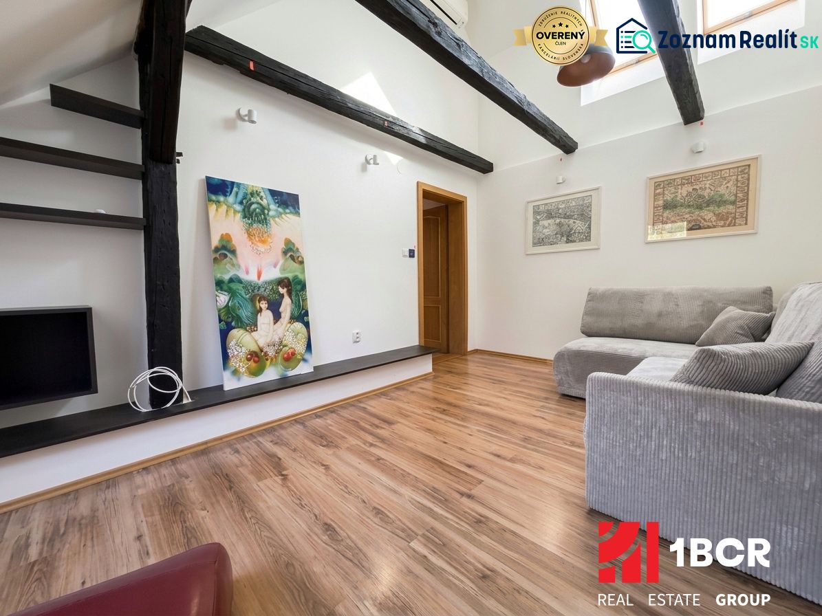 Interior of a 2-room apartment with a wooden decor floor and a comfortable sofa.
