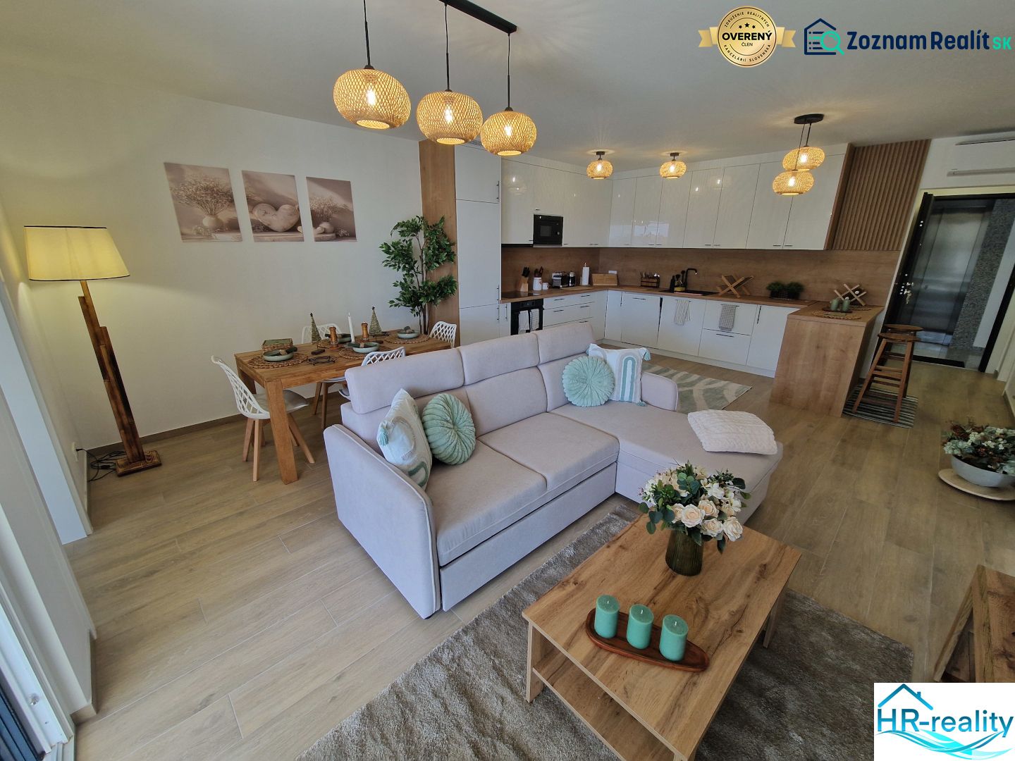 Living room of a 3-room apartment with a wooden decor floor, dining table, and sofa.
