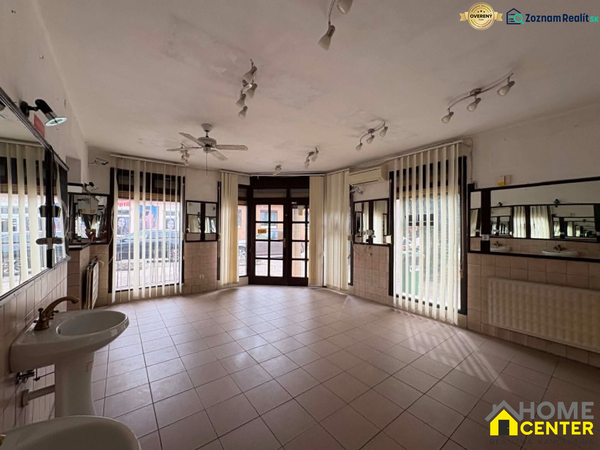 Spacious commercial spaces with sinks and mirrors, suitable for various uses.