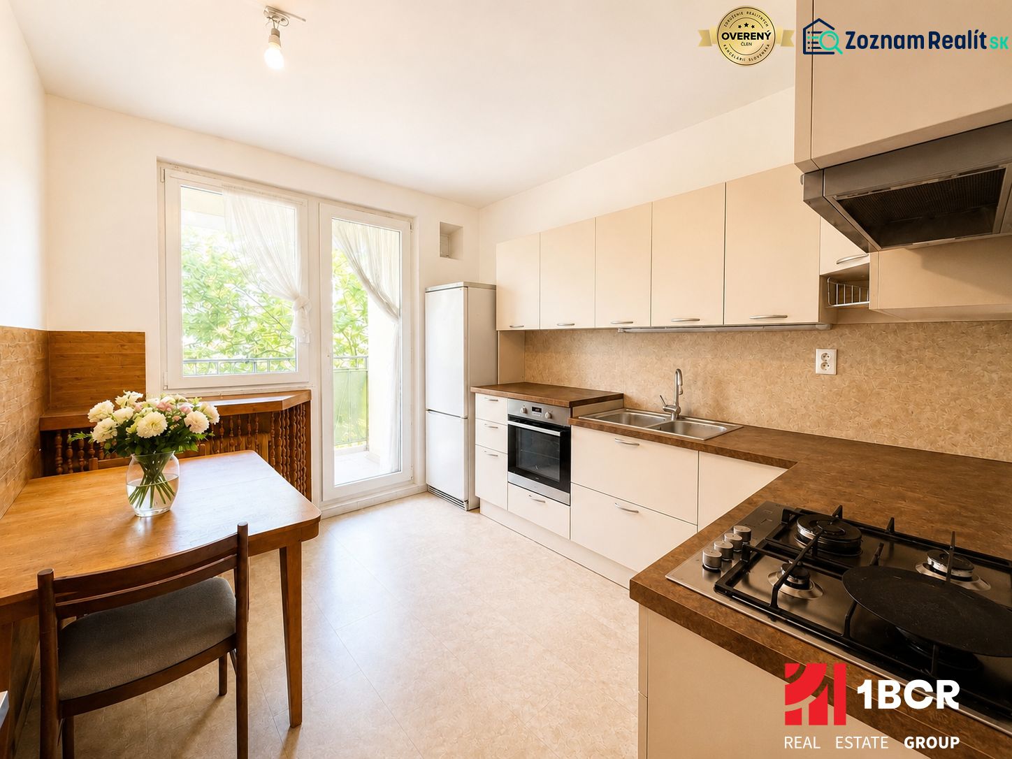 A kitchen in a 3-room apartment with a gas stove and a wooden table.