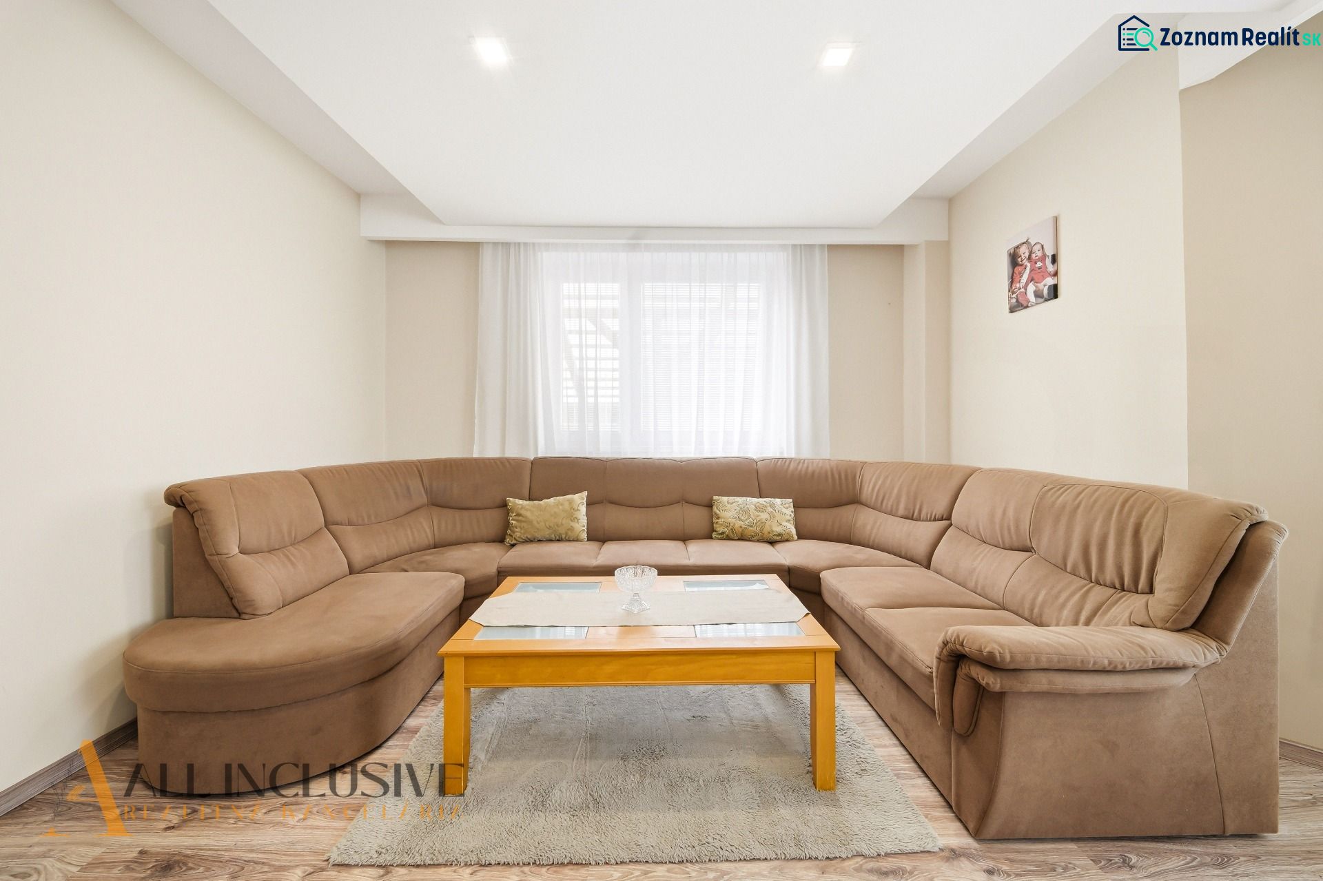 Bright living room in a family house with a comfortable sofa and a coffee table.