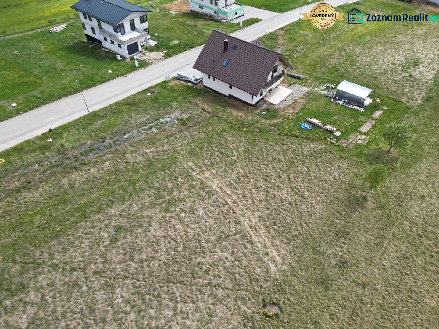 Aerial view of residential plots in Malý Slavkov by the road.