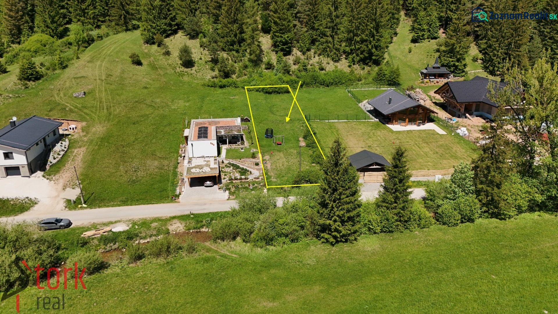 Residential plots in Rajecká Lesná surrounded by greenery and coniferous forests.