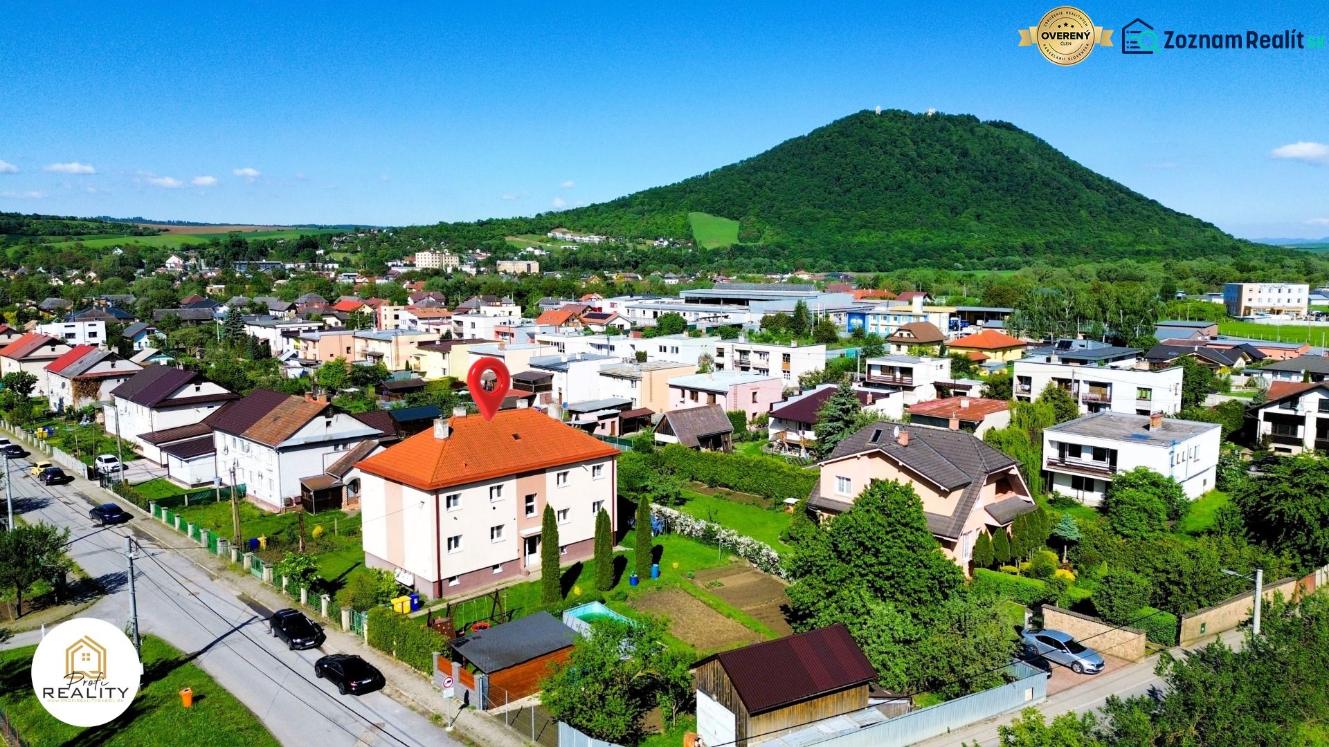 Veľký Šariš, Matice Slovenskej Street with a view of the hills and a residential area.