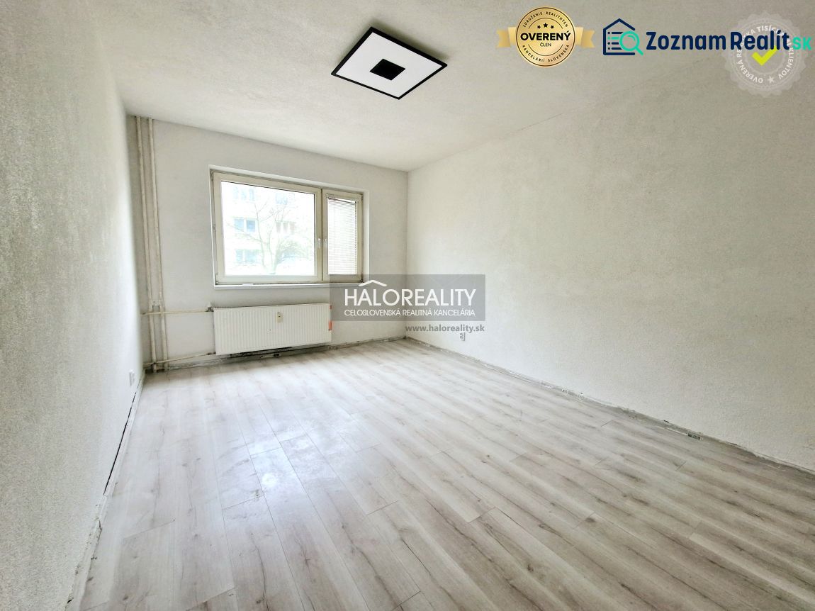 A room with a window and a radiator, a floor with a wooden decor in a 2-room apartment.