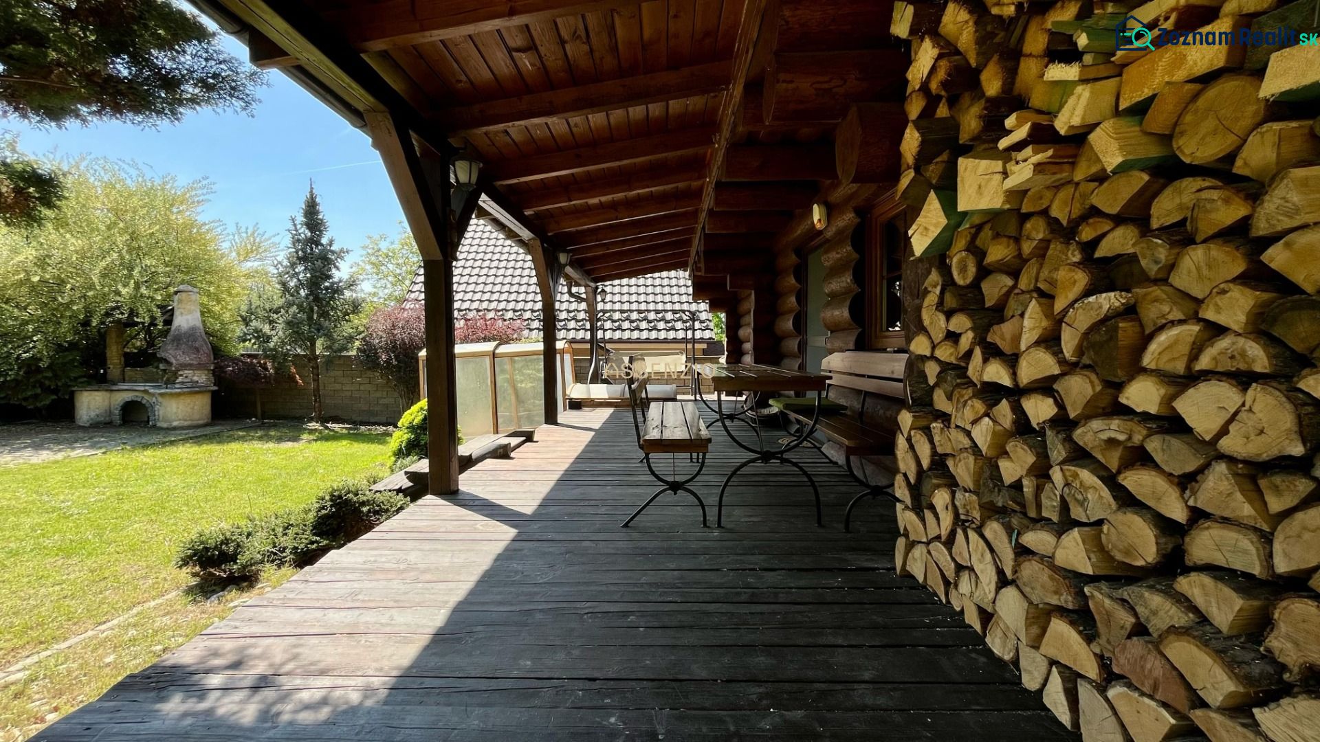 A family house with a wooden terrace and a supply of wood in Devínske Jazero, Bratislava.
