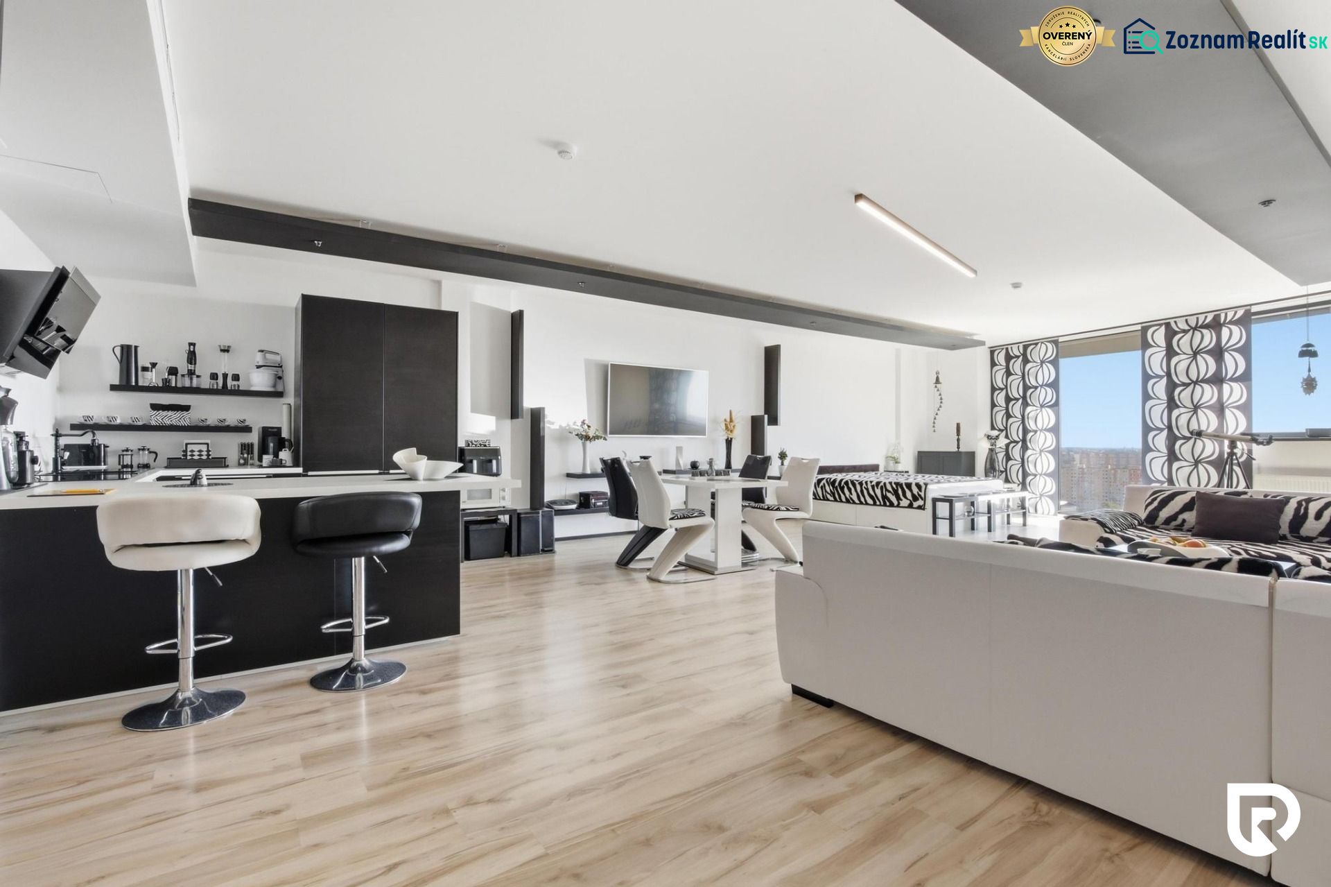 Spacious living area in a 2-room apartment with wood-patterned flooring.