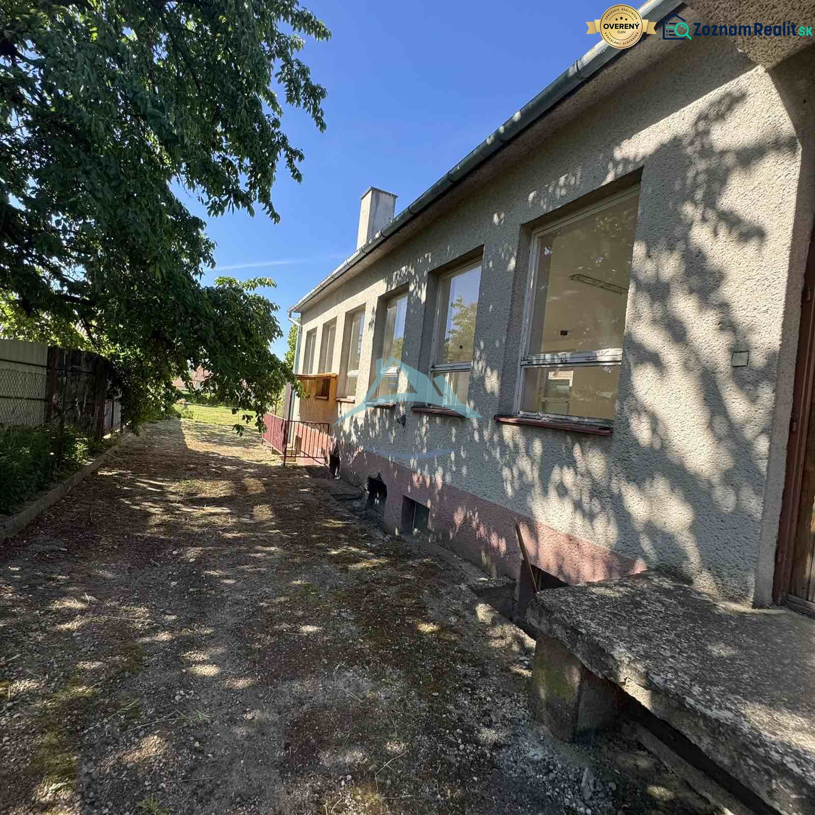 A building with windows and a shady sidewalk on Ľudovíta Štúra Street in Šahy.