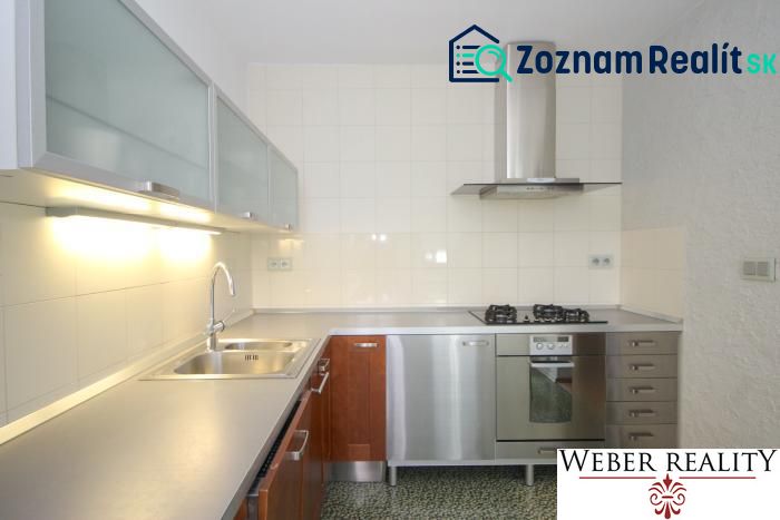 A kitchen in a 3-room apartment with stainless steel equipment and a laminate countertop.