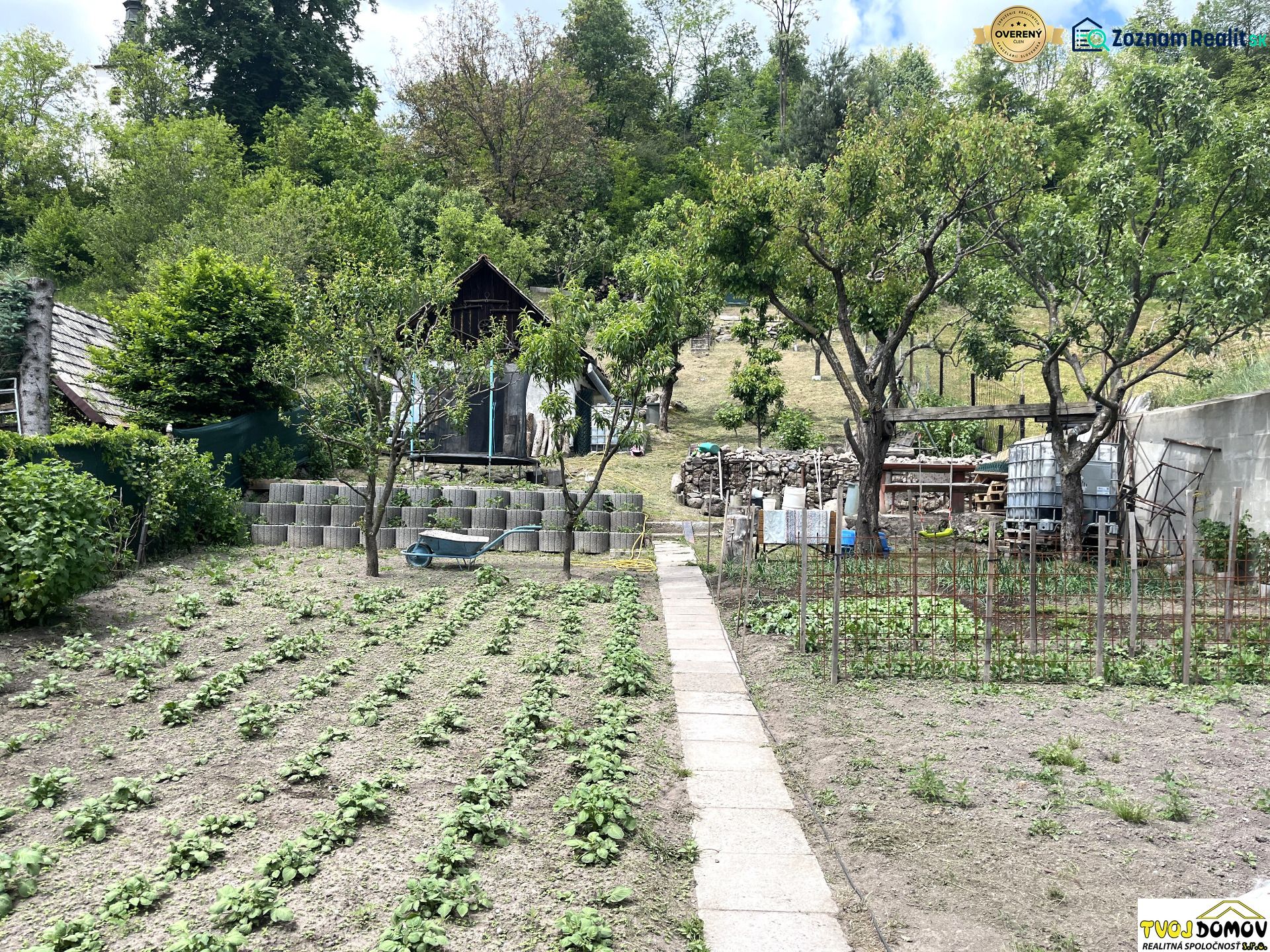 A garden at a family house in Bartošova Lehôtka with rows of planted plants and trees.