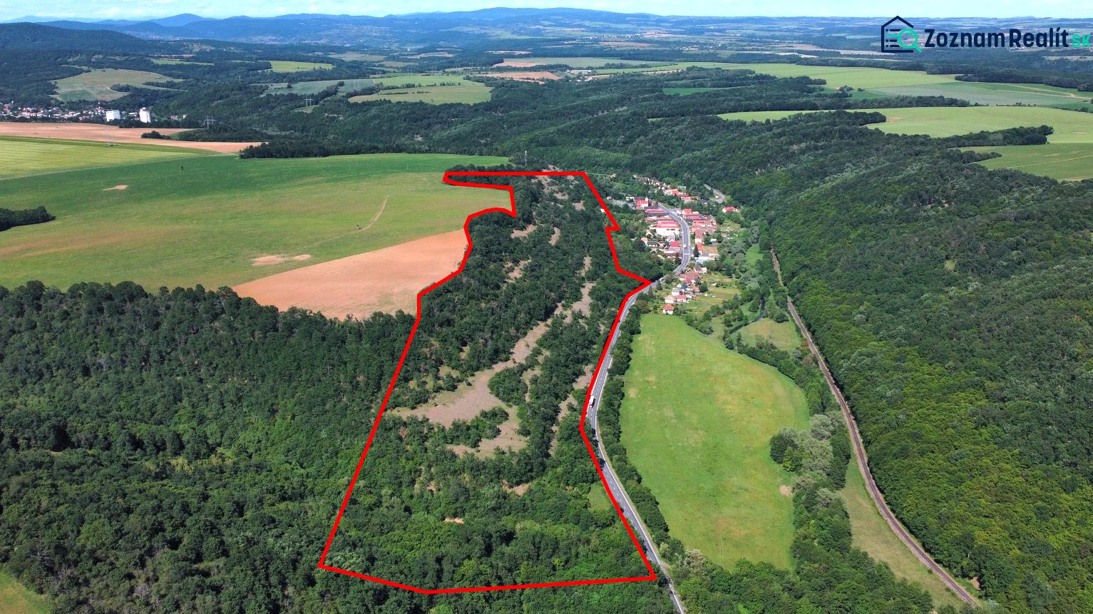 A view of agricultural and forest land in the Domaníky area with a landscape panorama.