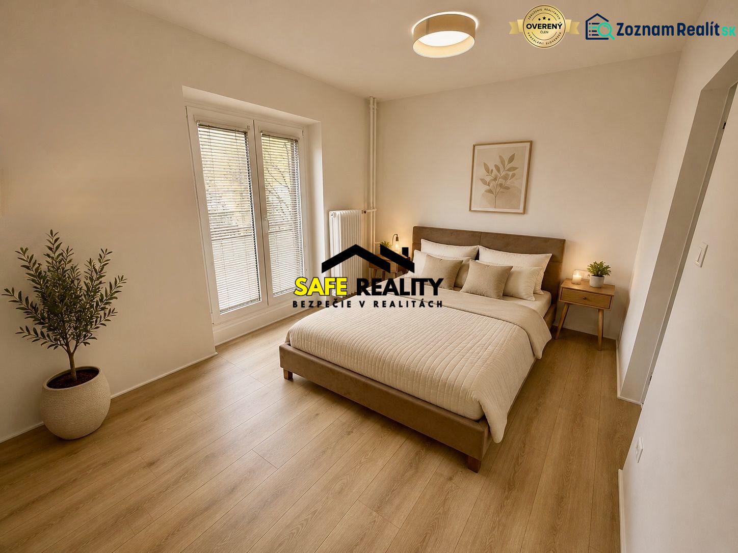 A bedroom in a 3-room apartment with a wooden decor floor and a potted plant.