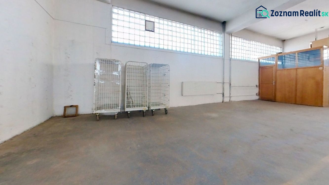 Warehouses and halls with empty space, sliding trolleys, and a glass partition.