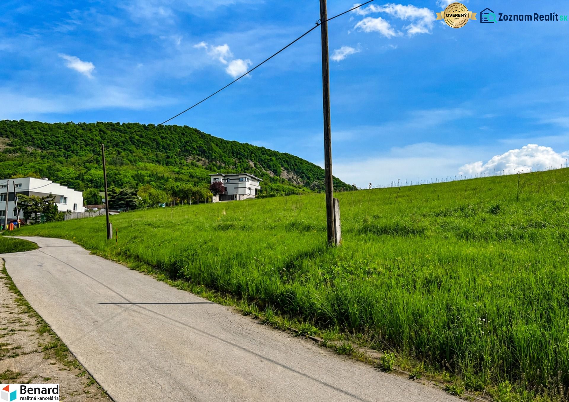 Hilly landscape near Fintice with residential plots and countryside in the background.