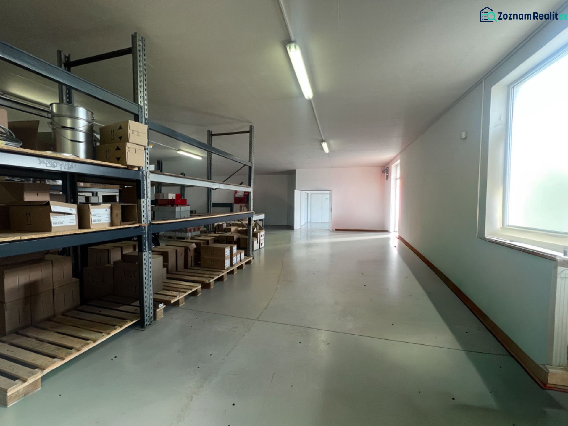 Glass shelves with boxes in warehouses and halls, illuminated by natural light.