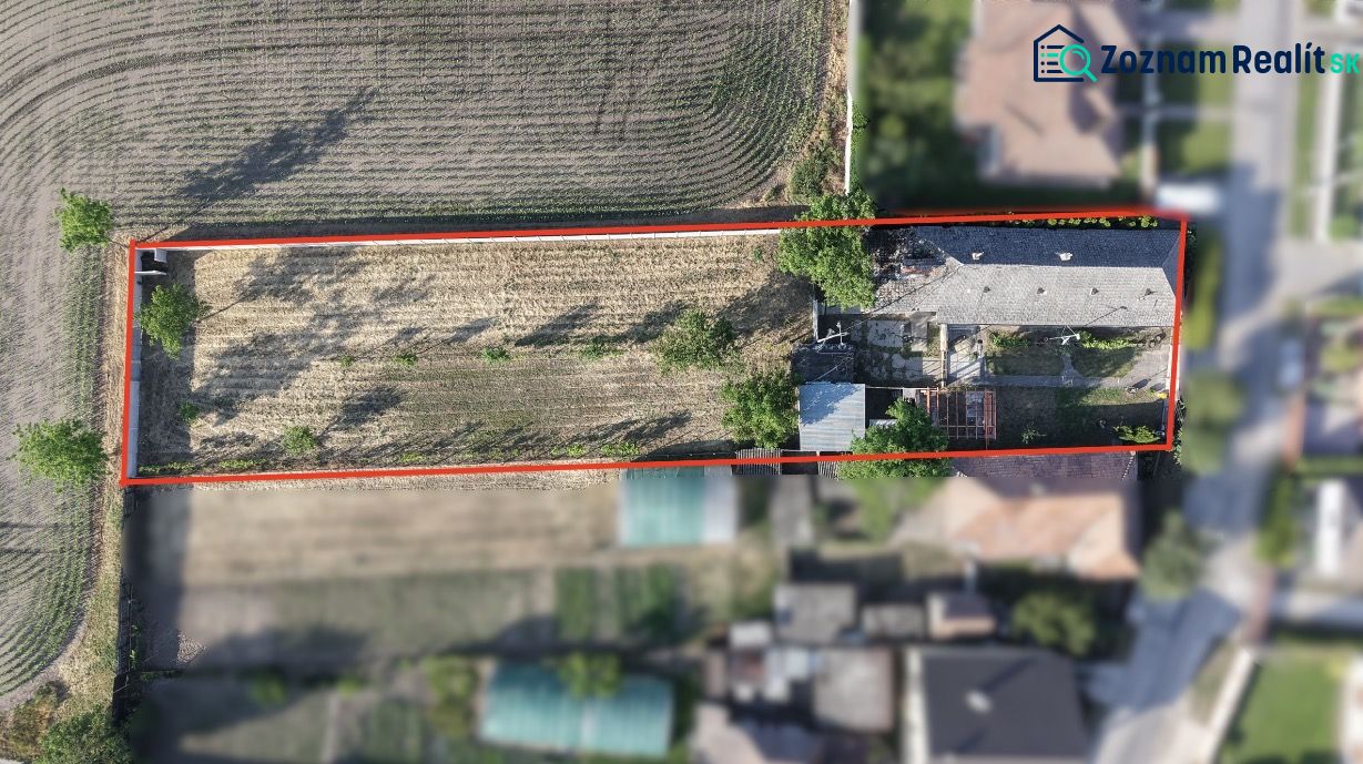 Aerial view of a family house complex in Nesvady with an adjacent plot of land.