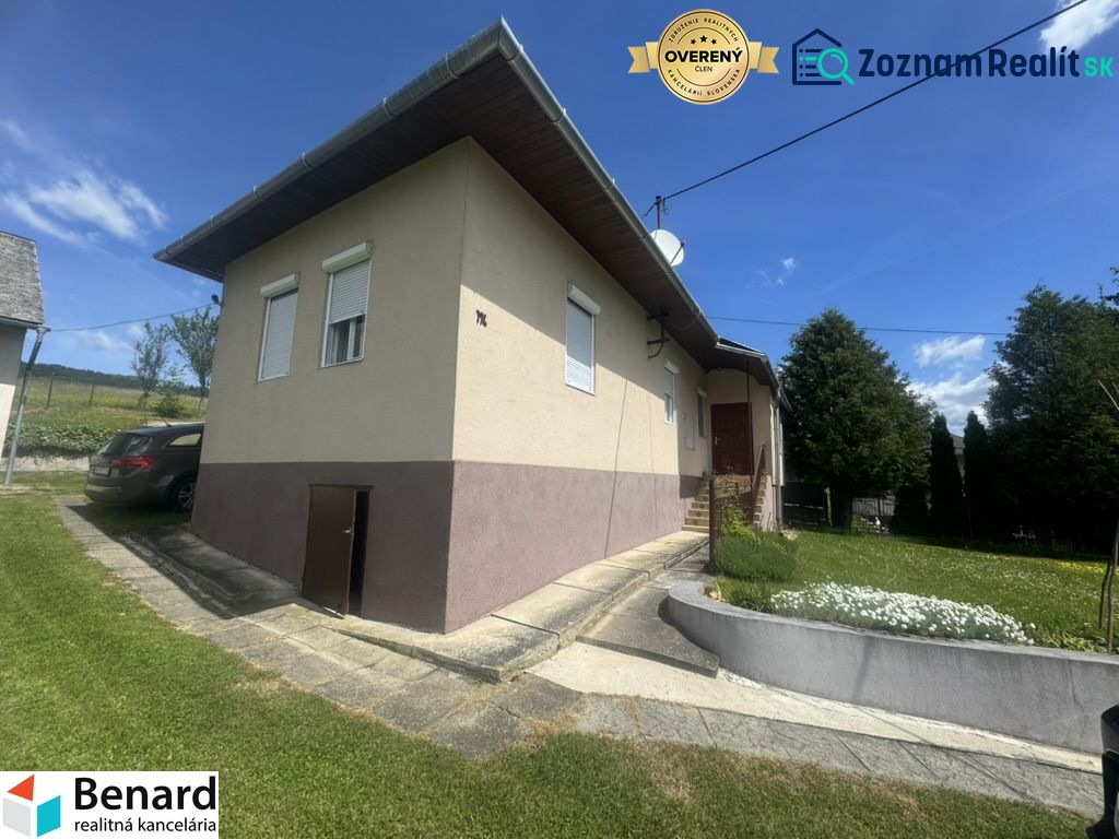 A family house in Orlov with a driveway, a car, and a landscaped garden.