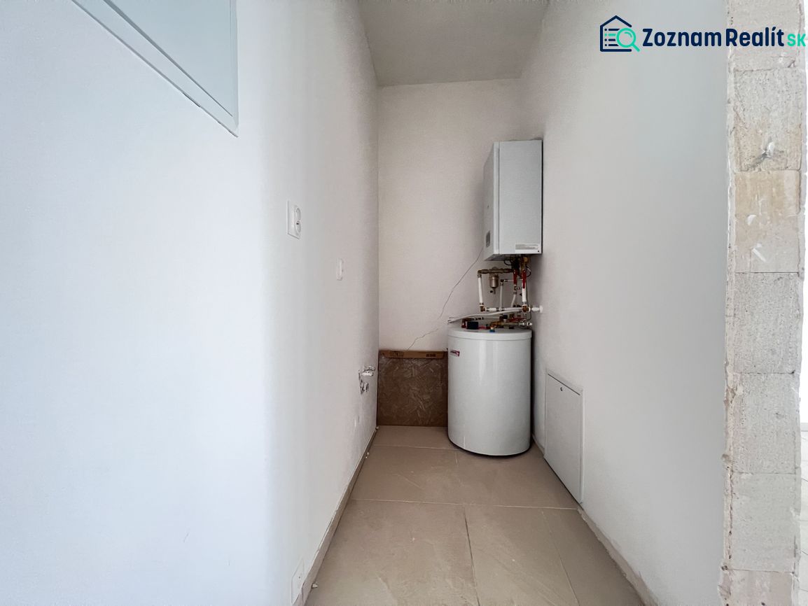 Technical room in commercial premises with a boiler and a tank-mounted heater.