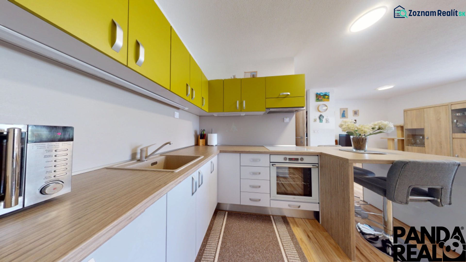 A kitchen with colorful cabinets and a wood-patterned floor in a 3-room apartment.