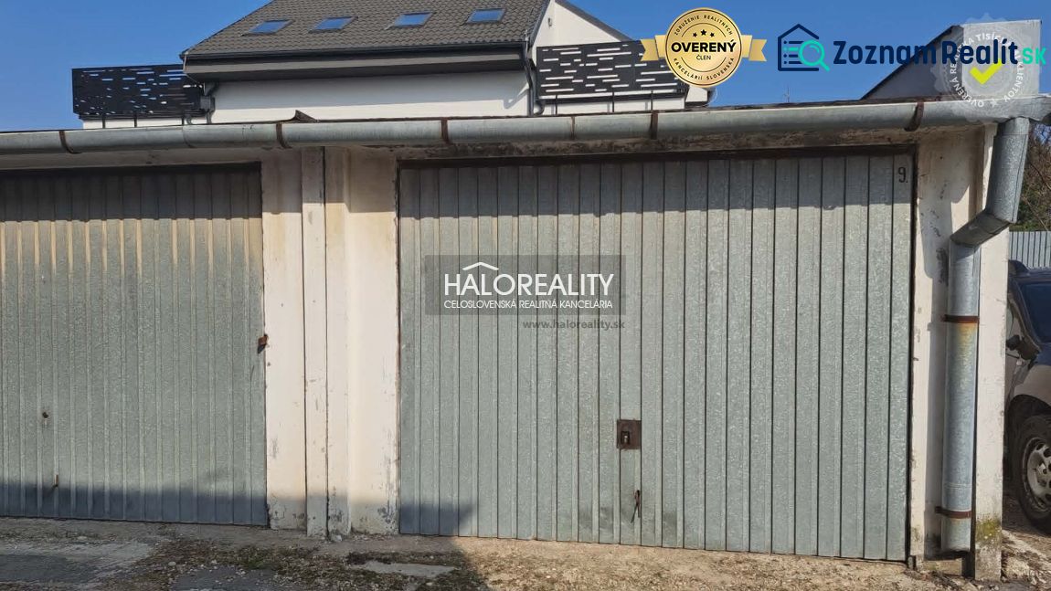 Garages in Senec with metal gates and a building roof.