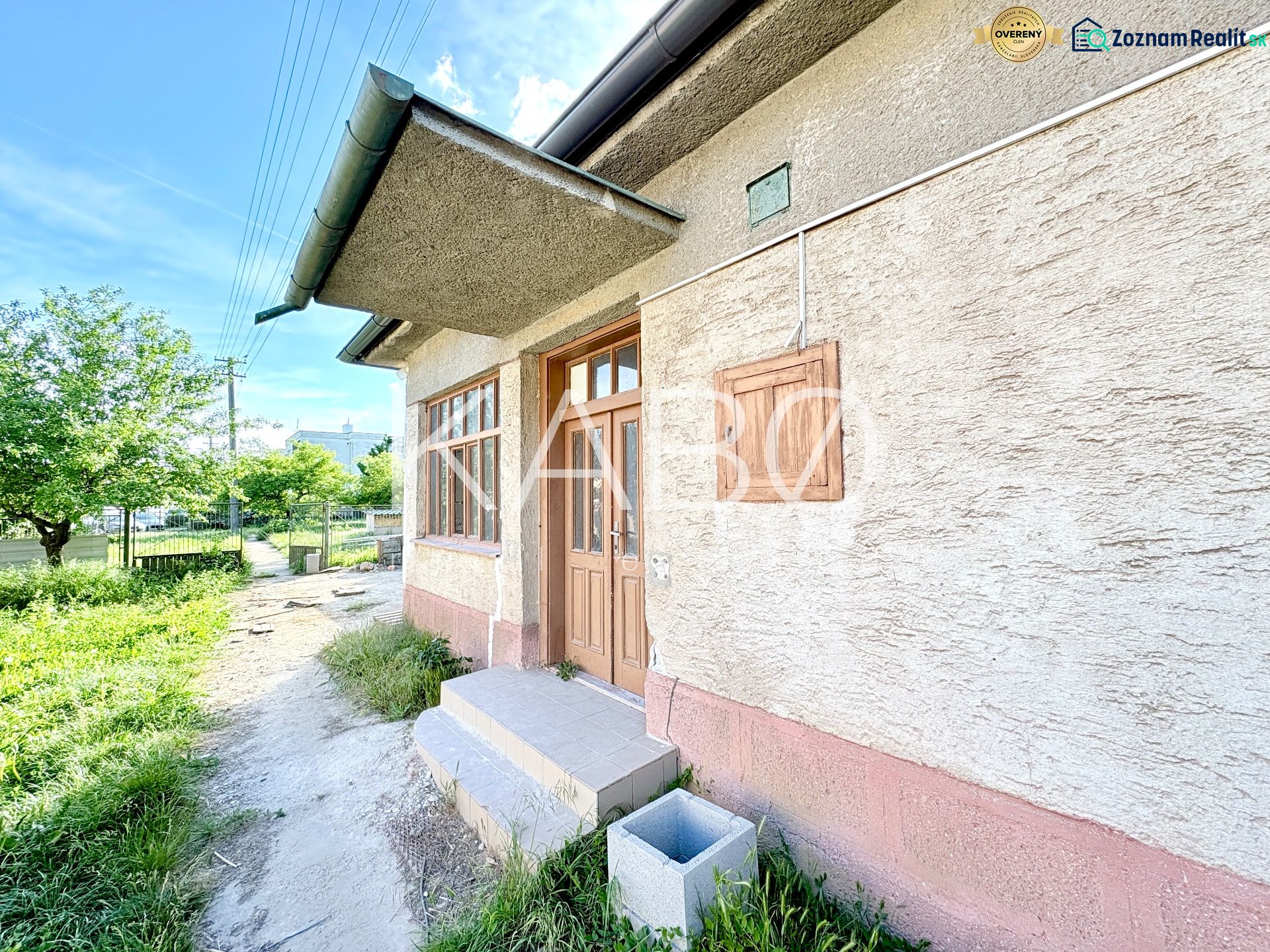A family house in Šoporňa with an external entrance and a green front garden.