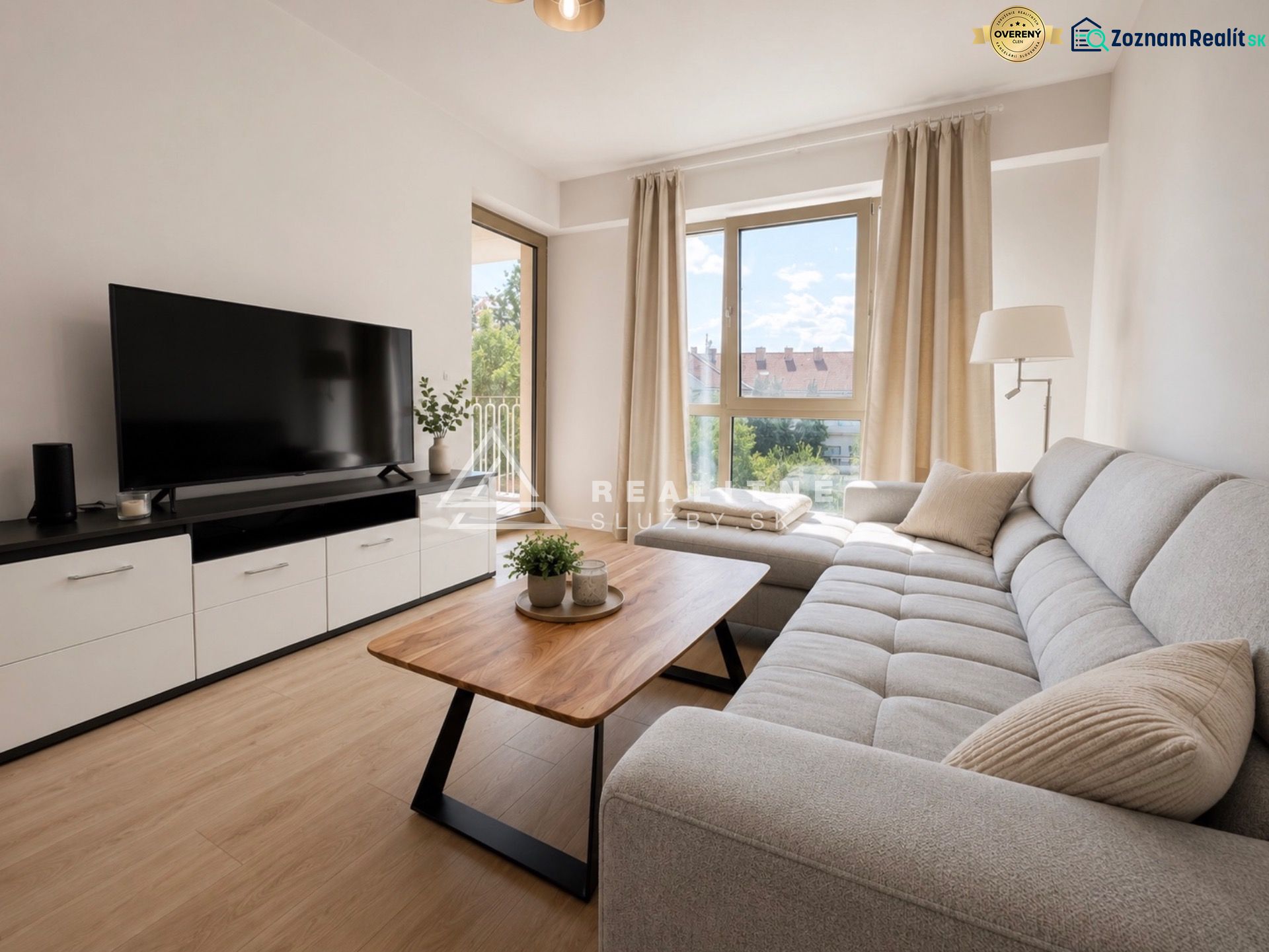 Living room in a two-room apartment with a sofa and a wooden decor floor.