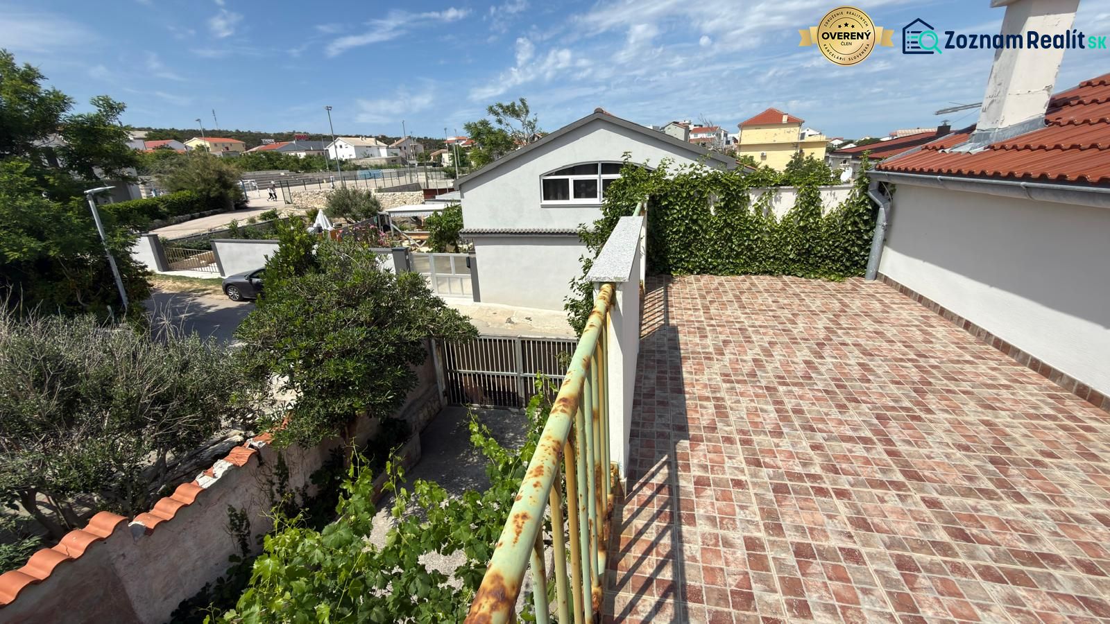 View from the terrace of a family house in Ražanac overlooking the roofs and greenery.